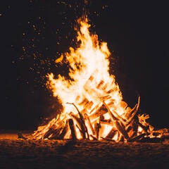 A bon fire at night, above it in a handwritten text are the words 'ritual six'