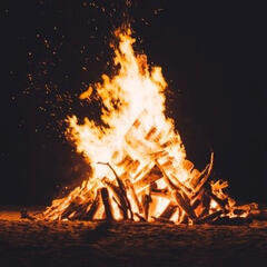 A bon fire at night, above it in a handwritten text are the words 'ritual six'
